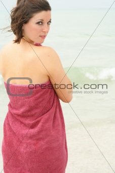 shot of a brunette covering herself with a towel