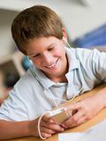 Young Boy  Playing With An MP3 Player