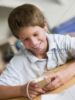 Young Boy  Playing With An MP3 Player