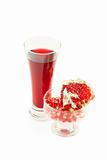 Glass of omegranate juice and  grains and a pomegranate piece. O