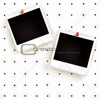 White peg board with photo frames