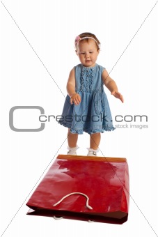 Cute little girl with paper bag, isolated