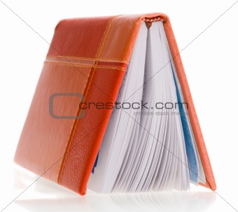 Personal organizer standing on its cover, isolated