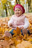 Smiley girl on yellow leaves