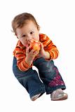 Child sitting and eating an apple, isolated