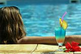 girl in pool with cocktail