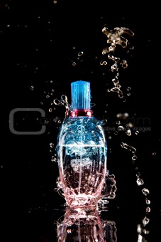 Perfume bottle with water splashes