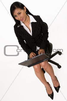 Woman sitting and working on laptop