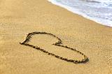 "Heart" drawing at sand, with sea wave