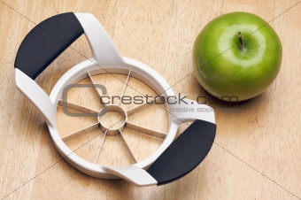 Apple and Slicer on a Wood Background