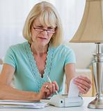 Senior woman calculating finances