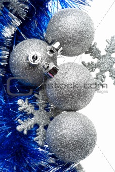 Silver bulbs with snowflakes and blue tinsel