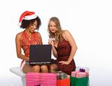 Two women: Christmas online shopping using laptop