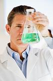 scientist holding up jar of chemicals