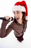 teen singer with mic and christmas hat