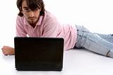 laying man with laptop