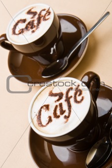 Two cups of fresh cappuccino