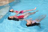 Girls Floating in a Swimming Pool