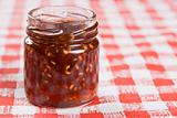 A small jar of raspberry jam