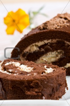 Sliced chocolate roll with a fresh flower