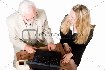 Two business associates sitting at a table with a laptop