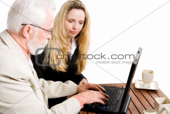 Two business colleagues working on a laptop
