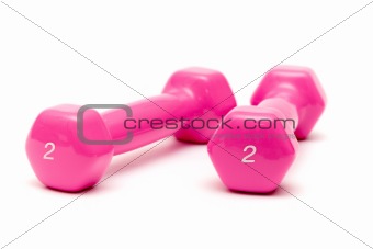 two pink dumbbells on the white background