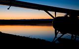 Seaplane by Side of Lake at Sunset