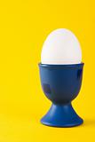 White egg in a blue egg cup