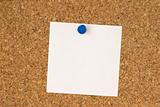 White note pinned to cork board