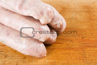 Five uncooked sausages