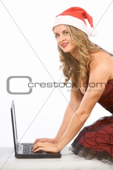 Sexy Mrs Santa Claus and portable laptop computer