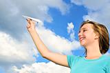 Young girl holding paper airplane