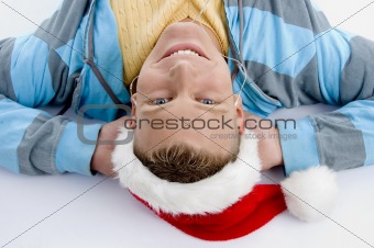 laying smiling man with christmas hat