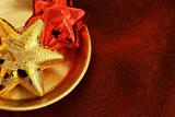 Golden and red stars on a golden plate