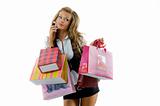 Happy young woman on a shopping spree. Talking by phone