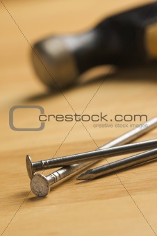 Hammer and Nails Abstract on Wood Background.