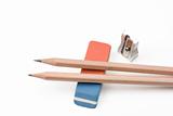 a pen, a sharpener and an eraser