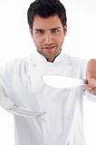 portrait of male chef holding cutlery