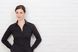 Businesswoman standing against wall