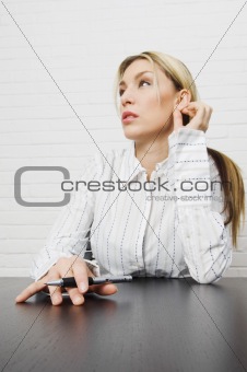 Attractive businesswoman thinking while on computer