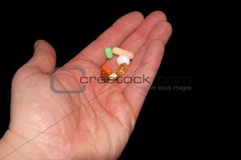 Drugs in hand isolated on black