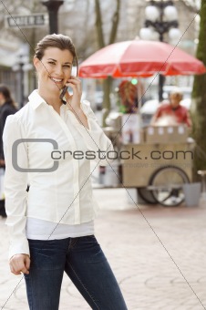 Talking on cell phone by hot dog stand