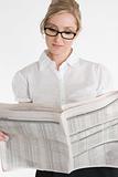 Businesswoman reading financial newspaper