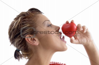 side face of woman licking a heart