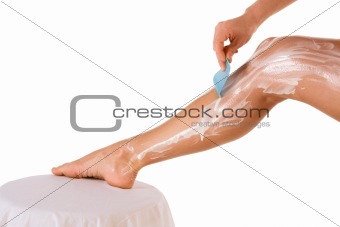 Shaving - woman removing leg hair (close up)
