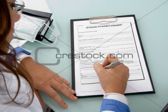 back pose of doctor writing on notepad