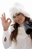 woman holding binocular and showing okay hand gesture