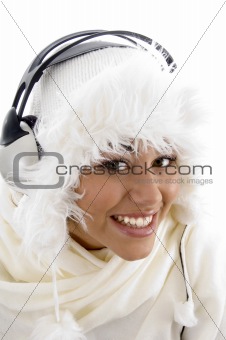 pretty girl wearing winter clothes and listening to music