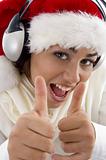 woman wearing christmas hat and showing thumbs up